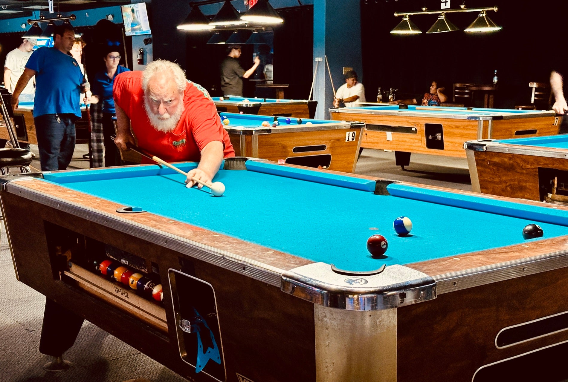 Players competing on the tables during a NAPA of Pensacola league night at Nine Mile Billiards