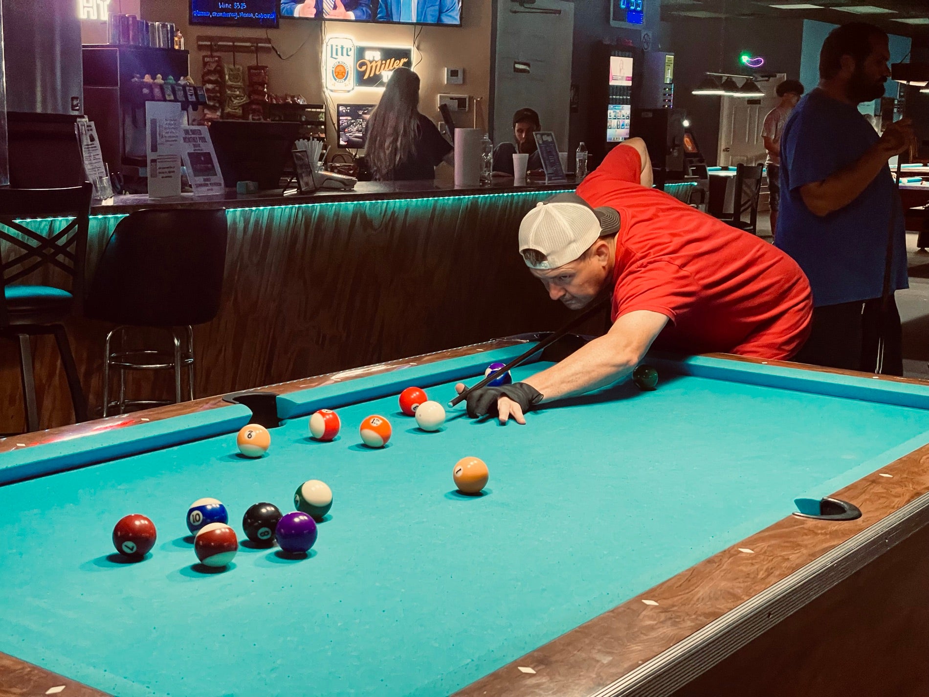 A NAPA of Pensacola player lining up a shot at Nine Mile Billiards