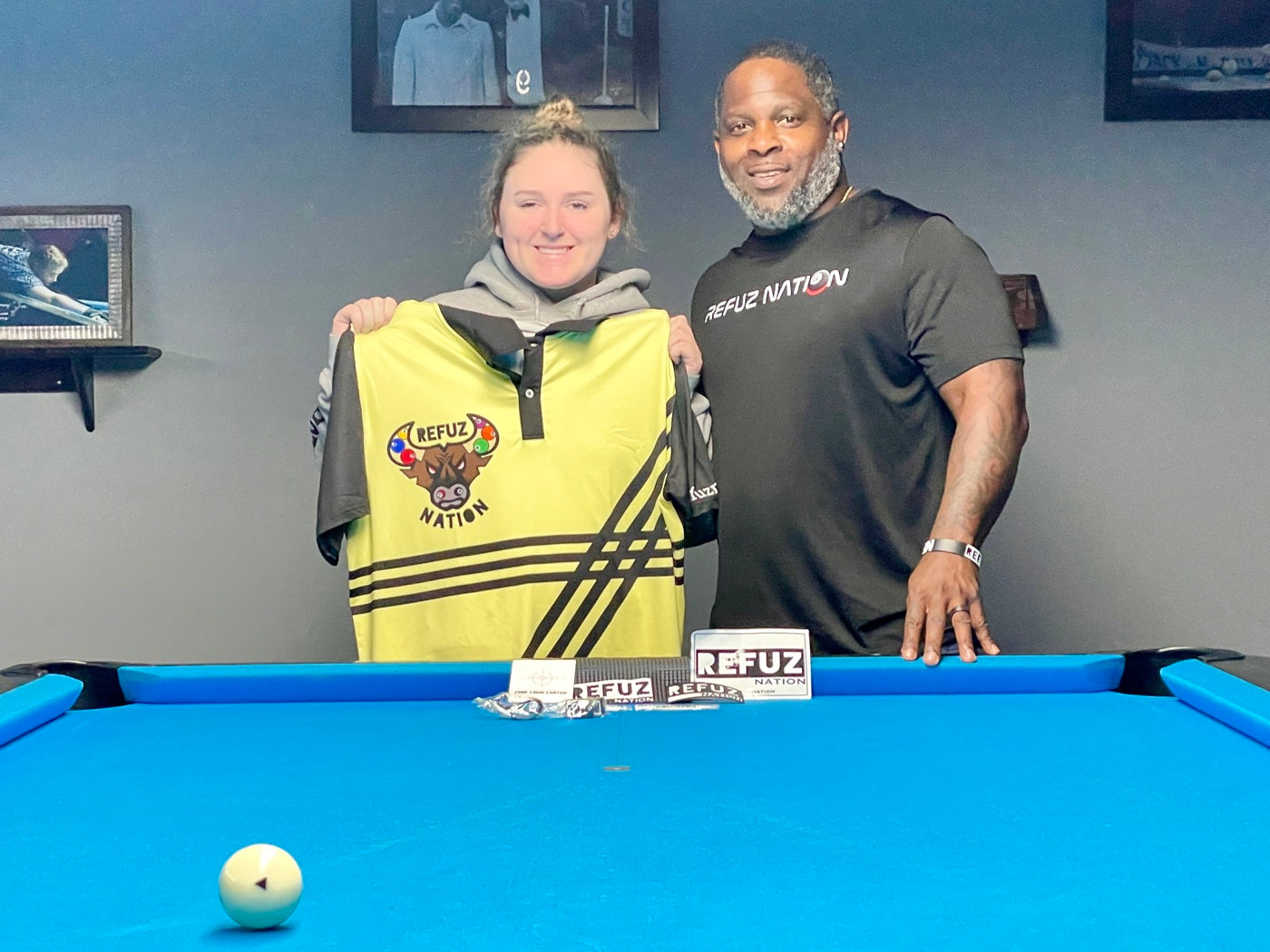 The instructor presenting a Refuz Nation jersey to a player