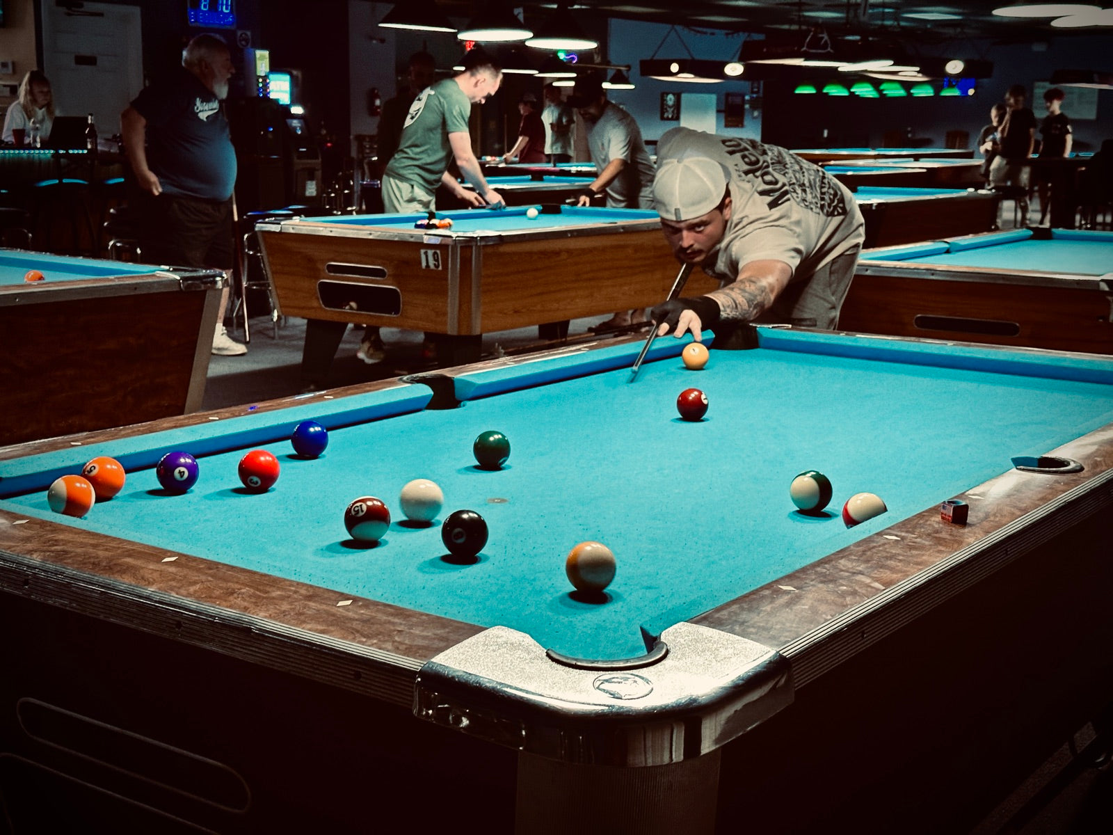 A NAPA of Pensacola player breaking into a full rack during a singles match at Nine Mile Billiards