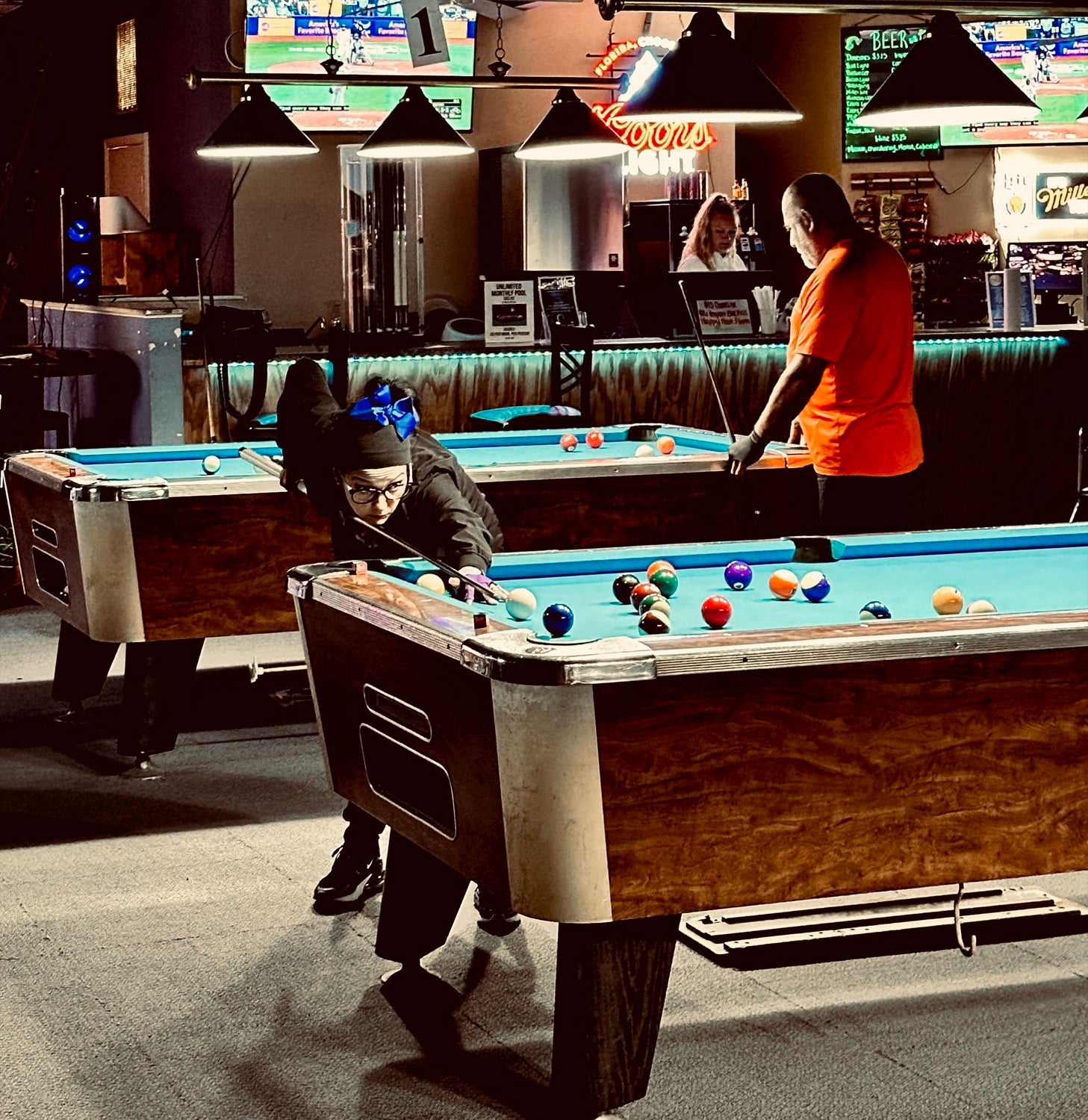 A young NAPA of Pensacola player lining up a shot at Nine Mile Billiards — all ages and skill levels welcome