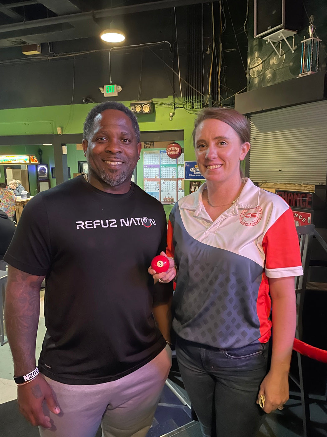 The instructor with a competitive player at Nine Mile Billiards