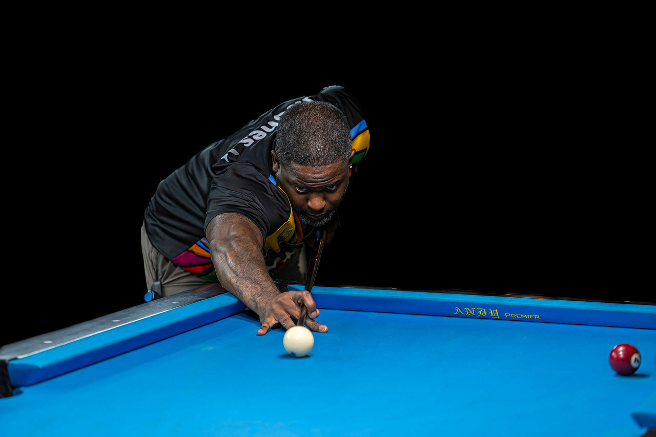A NAPA of Pensacola player focused on a precise shot under dramatic lighting